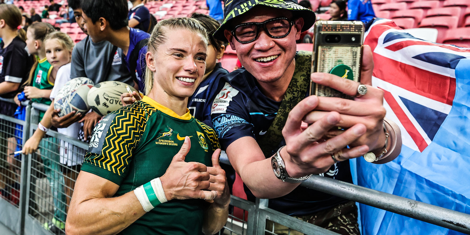 Nadine Roos with a South African fan in the stands in Singapore after the final match.