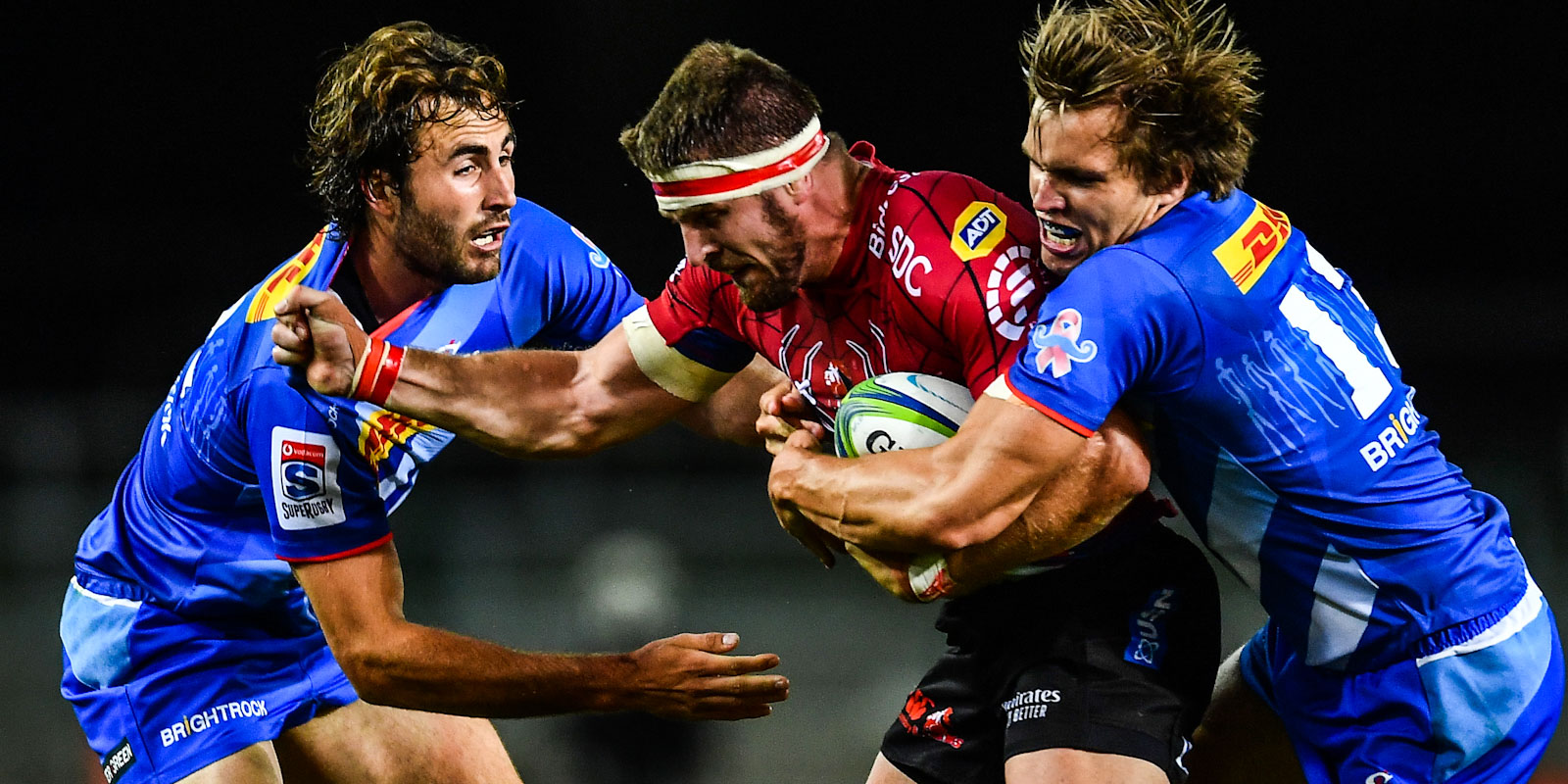 DHL Stormers midfielders Rikus Pretorius (left) and Dan du Plessis attempt to tackle Jaco Kriel of the Emirates Lions.