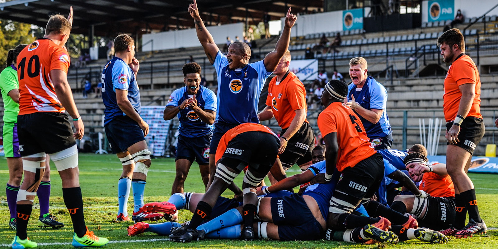 CUT celebrate as Johannes Terblanche goes over for the first try of the match against UJ.